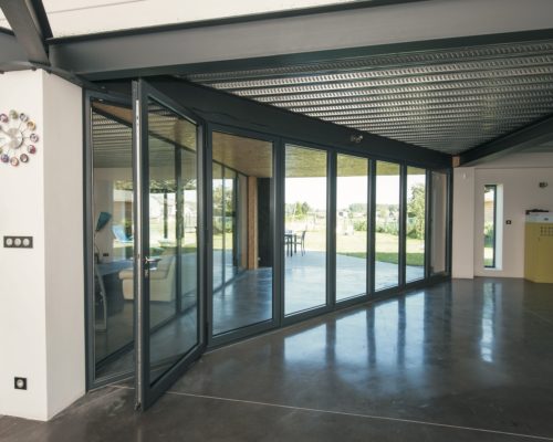 Reynaers bifold doors showing the CF77 model in a house lobby