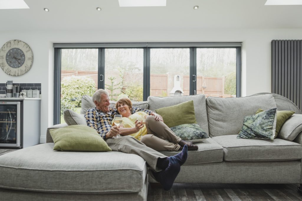picture of happy homeowners explaining the benefits of bi-fold doors