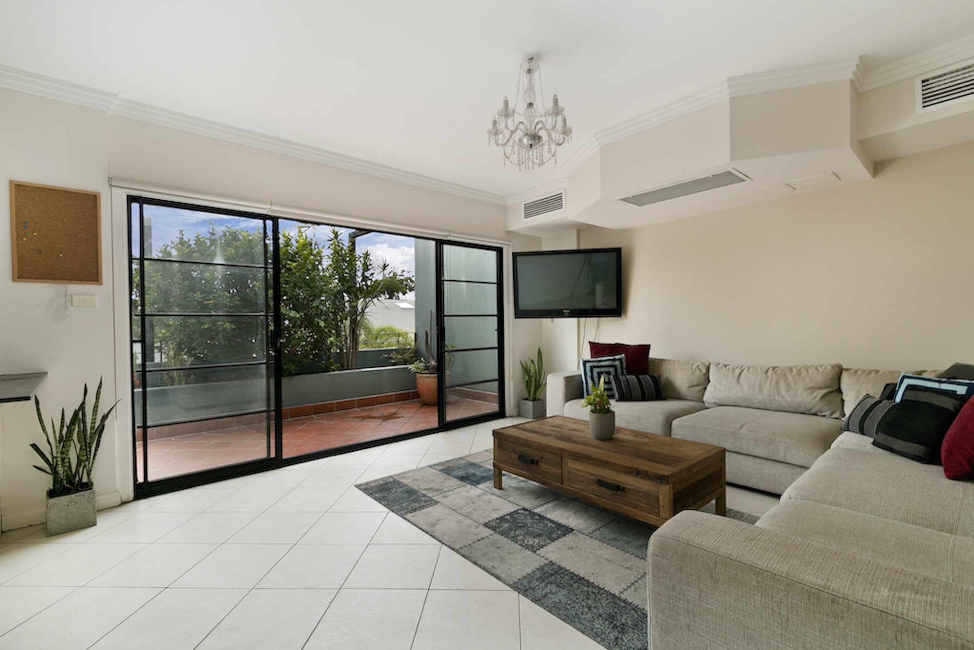 steel-look sliding doors to a living room and balcony