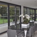 Reynaers CF68 Bifold doors in a dining room setting.